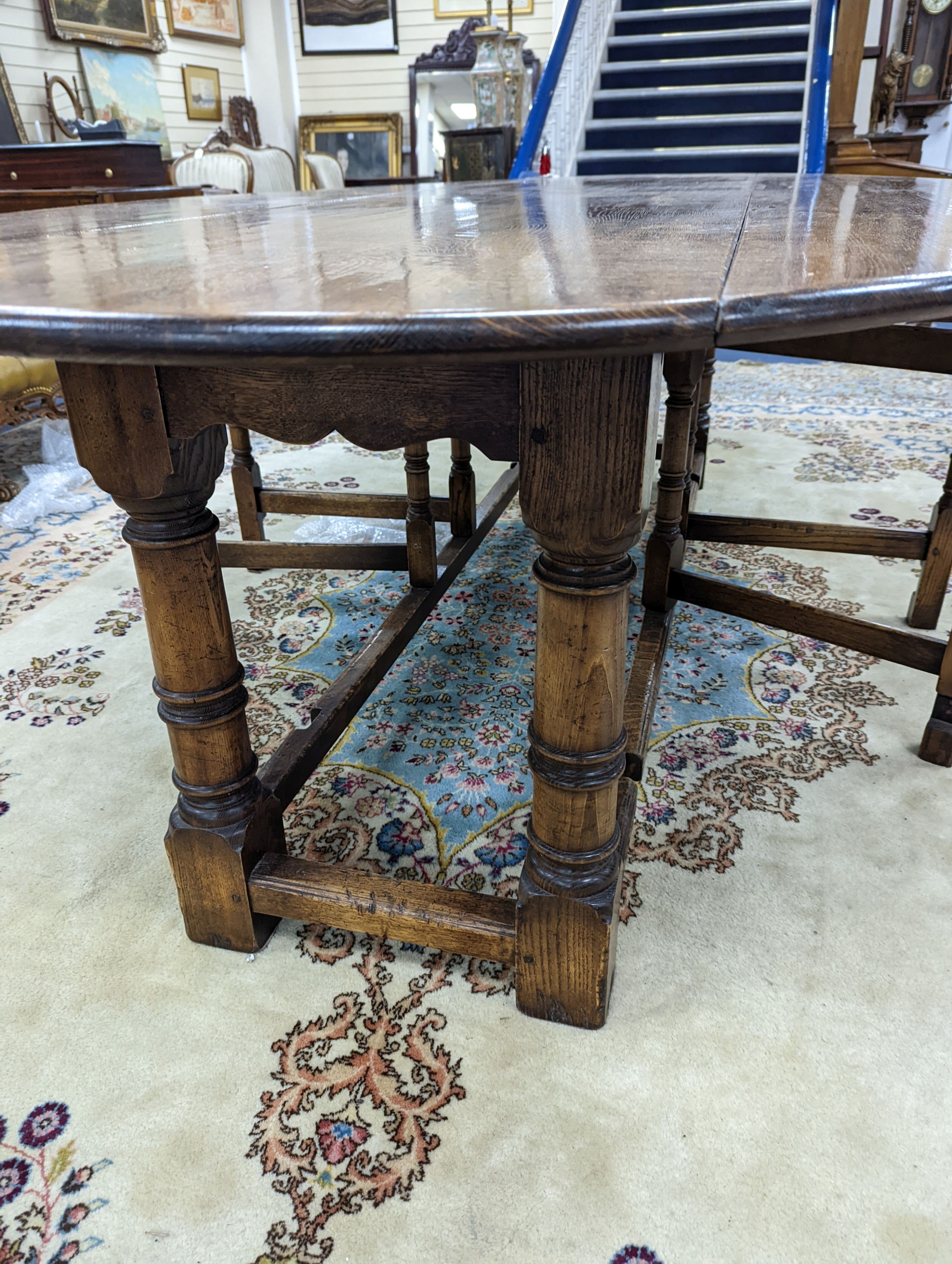 An 18th century style oak gateleg wake table, length 250cm, width 154cm extended, height 75cm